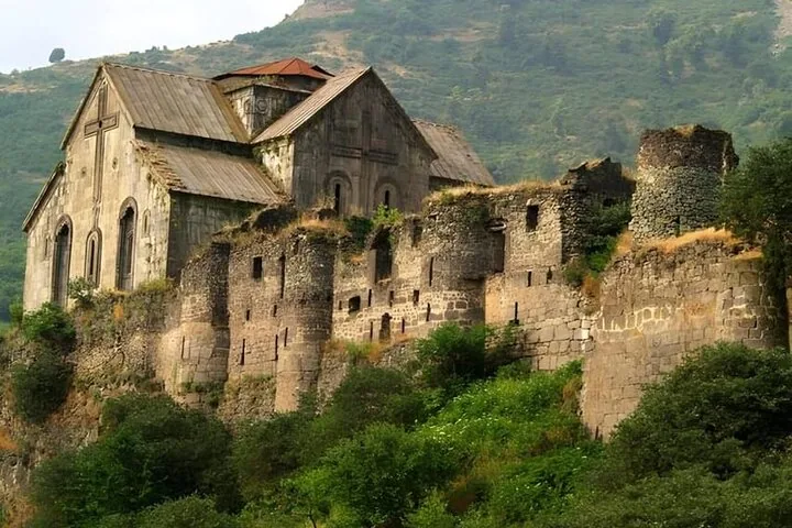 Ancien monastère en pierre construit sur une pente rocheuse abrupte
